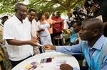 Presidential candidate and leader of the National Democratic Congress (NDC) John Atta Mills receives his ballot from a polling agent as he prepares to vote during presidential elections in Accra, Ghana, Sunday Dec. 28, 2008. Ghanaians returned to the polls Sunday for a presidential runoff vote with Nana Akufo-Addo of the ruling party facing opposition candidate John Atta Mills in an election expected to further solidify the country's status as one of Africa's few stable democracies.