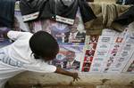 A Ghanaian boy points to pictures of candidates on posters supporting ruling party candidate Nana Akufo-Addo, along a wall outside his home in the Chorkor neighborhood of Accra, Ghana, Saturday, Dec. 6, 2008. Voters in this coastal African nation are acutely aware of the responsibility they bear when they head to the polls Sunday to elect their next president. The candidate they elect will mark the country's second successive transfer of power, a litmus test for a mature democracy and a feat tha