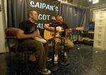 Quarter Master Seaman Jeff M. Schulze Bangs on a drum while Operations Specialist 3rd Class Joseph A. Burns plays guitar and vocals during Saipans Got Talent.