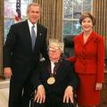 Ray Bradbury receiving the National Medal of Arts Award in 2004 with President George W. Bush and his wife Laura Bush.