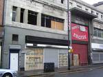 North Street Arcade, with graffiti alleging that the 2004 fire was deliberate. The extent of private development in the Cathedral Quarter has led to criticism from the area's residents as to the intentions of Laganside Corporation in the area