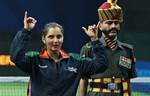 India's bronze medalist Sania Mirza gestures as she jokes with an Indian soldier in ceremonial dress following the finals for the women's doubles at RK Khanna Tennis Stadium at the Commonwealth Games in New Delhi, India, Sunday, Oct. 10, 2010. (AP Photo/Kevin Frayer)at the R.K. Khanna Tennis Stadium at the Commonwealth Games in New Delhi, India, Sunday, Oct. 10, 2010.