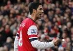 Arsenal's Mikel Arteta celebrates his goal against Queens Park Rangers during their English Premier League soccer match at Emirates stadium, London, Saturday, Oct. 27, 2012.