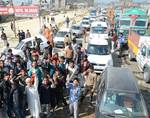 Kashmiri muslims block traffic on Srinagar- Barmulla National Highway during a protest in Srinagar, India, on Friday 12, October 2012. Strike called by (KEA) Kashmir economic Alliance an amalgam of trading bodies seeking an increase in the number of subsidised LPG cylinders in the Valley.