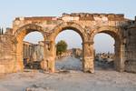 Frontinus Gate. This is the monumental entrance to the Roman city and leads onto the large plateia, 14 m wide, which crosses the whole settlement, exiting a gate at the opposite side, to connect with the road that goes to Laodicea on the Lykos and then Colossal.