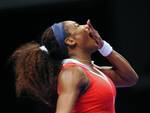 Serena Williams of the U. S. reacts to cheering spectators as she returns a shot to Maria Sharapova of Russia during their tennis match on the final of the WTA Championships in Istanbul, Turkey