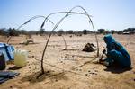 14 February 2012. Damra Toma: A woman builds her new shelter in Damra Toma (North Darfur). The village is now occupied by an arab nomadic community (Mahammid tribe) just returned after nine years displaced in several camps in South Darfur. The community, more than 1,000 households, left their original village in 2002 due to the insecurity situation. The community expect 200 households more coming in the next few days. Photo by Albert Gonzalez Farran - UNAMID