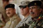 U.S. Army Lt. Col. Kenneth Casey (center), commander of 1st Battalion, 67th Armor Regiment, 3rd Brigade Combat Team, 25th Infantry Division, sits with Lt. Col. Hassan (front), commander of 2nd Battalion, 12th Brigade, 2nd Iraqi Army Division, during the turnover ceremony of Multi-National Force - Iraq, Combat Outpost Power in the Aden District of Mosul, Iraq.