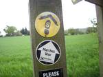 The distinctive waymarks of the Marches Way and Sandstone Trail near Old St. Chads Chapel, Tushingham, Cheshire.