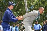 NASSAU, Bahamas - BM3 Ryan Anderson, with the U.S. Coast Guard, demonstrates handcuff procedures on Sgt first class Marlon Paimon from Paramaribo, Suriname, during 'compliant boarding' training for service members from the Royal Bahamas, St. Vincent and Grenadines, St. Kitts-Nevis, Haiti, Trinidad-Tobago, Belize, Barbados and the Dominican Republic Defence Forces at Royal Bahamas Defence Force Base Coral Harbour, March 6. The training is part of Exercise Tradewinds 2009. Tradewinds '09 is a Chai