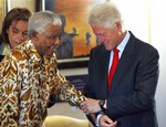  Former South African president Nelson Mandela, left, is escorted by former U.S. president Bill Clinton into the auditorium at the Mandela Foundation in Johannesburg, South Africa, Thursday July 19, 2007. The two opened an exhibition entitled &quot;Making