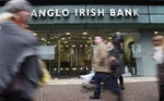 People pass by the northern headquarters of the Anglo Irish Bank in Belfast, Northern Ireland, Friday, Jan. 16, 2009. Anglo Irish Bank share trading was suspended Friday after the Irish government announced it was nationalizing the troubled lender, a move the EU said it will investig