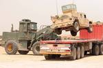 May 7, 2007. Camp Ramadi, Iraq. The driver of a Payloader places a HMMWV onto a Schmitz Trailer, which will be transported to Camp Taqaddum, Iraq, by 2D Maintenance Battalion Transportation Support Company. 2D Maintenance Battalion is deployed with Multi National Forces-West in support of Operation Iraqi Freedom in the Al Anbar province of Iraq to develop Iraqi Security Forces, facilitate the development of official rule of law through democratic reforms, and continue the development of a market