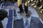 Palestinian Salafis "al-Qaeda" burning U.S. and Israeli flags as they burn image of U.S. President Barack Obama during a protest against what they said was a film being produced in the U.S. that was insulting to the Prophet Mohammad in Rafah in southern Gaza Strip on September 14, 2012. Palestinians Salafis "al-Qaeda" supporters staged demonstration in both the occupied West Bank and Gaza Strip on Friday to denounce the film, burning U.S. and Israeli flags and clashing with police in Jerusalem.Photo by Ahmed Deeb / WN