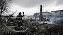 A fire fighter surveys the smoldering ruins of a house in the Breezy Point section of New York, Tuesday, Oct. 30, 2012. More than 50 homes were destroyed in a fire which swept through the oceanfront  community during superstorm Sandy. (AP Photo/Mark Lennihan)