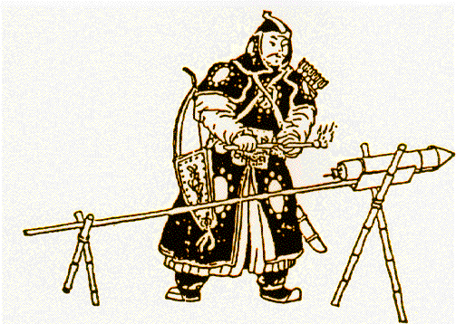 A man in black armor standing in front of a rocket, attached to a stick, with the stick being held up by two X shaped wooden brackets.