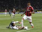 Inter Milan Brazilian goalkeeper Julio Cesar , left, tries to stop AC Milan midfielder Kevin Prince Boateng, of Ghana, right, during a Serie A soccer match between Inter Milan and AC Milan, at the San Siro stadium in Milan, Italy, Sunday, May 6, 2012.