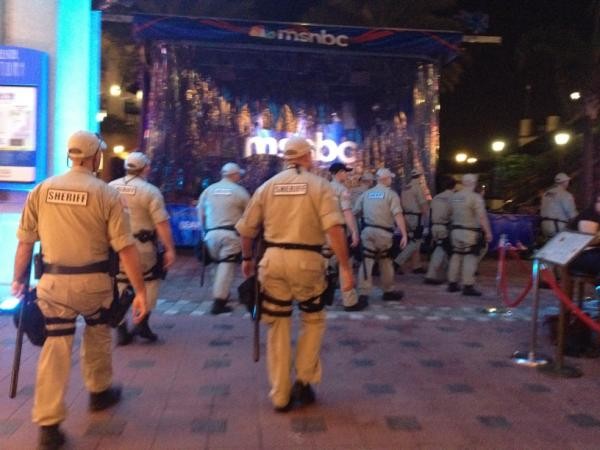 (A photograph of a crowd of sheriffs walking past an MSNBC pavilion.)