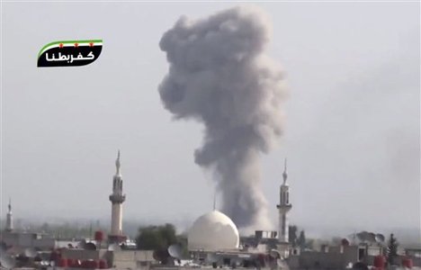 This image taken from video obtained from Shaam News Network, which has been authenticated based on its contents and other AP reporting, shows smoke rising from the city following heavy bombing from military warplanes, in a suburb of Damascus, Syria, on wednesday, Oct. 31, 2012.