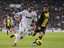 Real Madrid's Gonzalo Higuain from Argentina, left, in action with Zaragoza's Alvaro Gonzalez, during a Spanish La Liga soccer match at the Santiago Bernabeu stadium in Madrid, Spain, Saturday, Nov. 3, 2012.