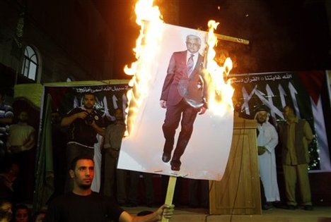 Palestinians march during a protest against president Mahmoud Abbas in the Jabaliya Refugee Camp, northern Gaza Strip Saturday, Nov. 3, 2012. Gazans protested against Abbas' remarks at an Israeli television that suggested millions of Palestinian refugees and their descendants would not be able to return to the places they fled.