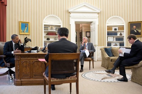 File - President Barack Obama has a foreign leader phone call in the Oval Office, Aug. 20, 2012.