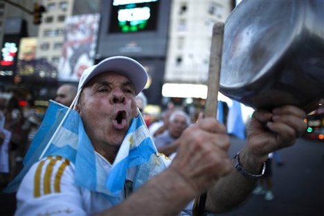 A protester bangs a pot during a march against Argentina's President Cristina Fernandez in Buenos Aires, Argentina, Thursday, Nov. 8, 2012.