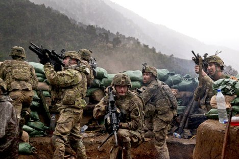 File - U.S. Soldiers with 2nd Battalion, 327th Infantry Regiment, 101st Airborne Division return fire during a firefight with Taliban forces in Barawala Kalay Valley in Kunar province, Afghanistan, March 31, 2011.