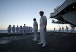 Capt. Kent D. Whalen, commanding officer of the Nimitz-class aircraft carrier USS Carl Vinson (CVN 70), and Command Master Chief April D. Beldo preside over a burial at sea ceremony.