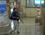 FILE - In this Nov. 26, 2008 file photo, Mohammed Ajmal Kasab, the accused gunman walks at the Chatrapathi Sivaji Terminal railway station in Mumbai, India.