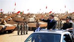 In this image released by the Egyptian Presidency, Egyptian President Mohammed Morsi, waves toward soldiers at a military base in Ismailia, Egypt, Wednesday, Oct. 10, 2012.