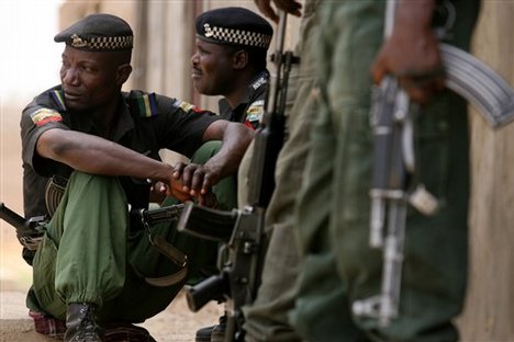 Nigerian police officers stand guard in an area were the military are battling with gunmen in Kano, northern Nigeria, Wednesday April 18, 2007.