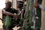 Nigerian police officers stand guard in an area were the military are battling with gunmen in Kano, northern Nigeria, Wednesday April 18, 2007.