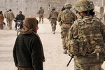 File - U.S. Army Capt. Peggy Hu, Zabul Provincial Reconstruction Team civil affairs, speaks with a local child during a routine patrol in the local area Nov. 21, 2012, in Afghanistan.