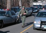 In this photo provided by the Newtown Bee, police officers are on the scene outside Sandy Hook Elementary School in Newtown, Conn., where authorities say a gunman opened fire, killing 26 people, including 20 children, Friday, Dec. 14, 2012.