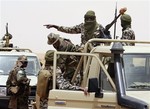 In this May 12, 2010 photo, Malian troops and soldiers from other African countries train with the U.S. Special Forces in the Sahara Desert near the town of Gao in northeastern Mali.