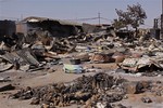 A local market that was destroyed in recent violence at Jos, Nigeria, Wednesday, Jan. 20, 2010. Charred bodies with scorched hands reaching skyward lay in the streets and a mosque with blackened minarets smoldered Wednesday after several days of fighting between Christians and Muslims killed more than 200 people.