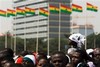 A girl sits on an adult's shoulders to get a better view as she waits among a crowd prior to the ceremony held for the inauguration of Ghana's new President John Atta Mills in Accra, Ghana Wednesday, Jan. 7, 2009. The election of Mills, in the closest vote in Ghana's history, makes the West African nation one of the few African countries to successfully transfer power twice from one legitimately elected leader to another.