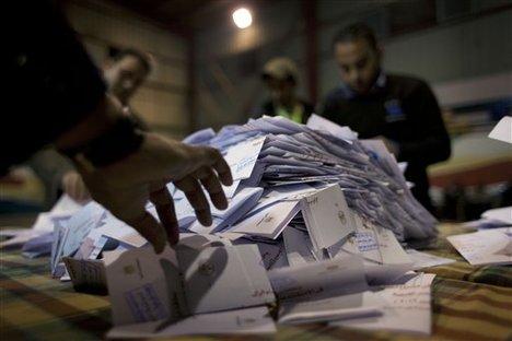 Egyptian election workers count ballots at the end of the second round of a referendum on a disputed constitution drafted by Islamist supporters of president Mohammed Morsi at a polling station in Giza, Egypt, Saturday, Dec. 22, 2012.