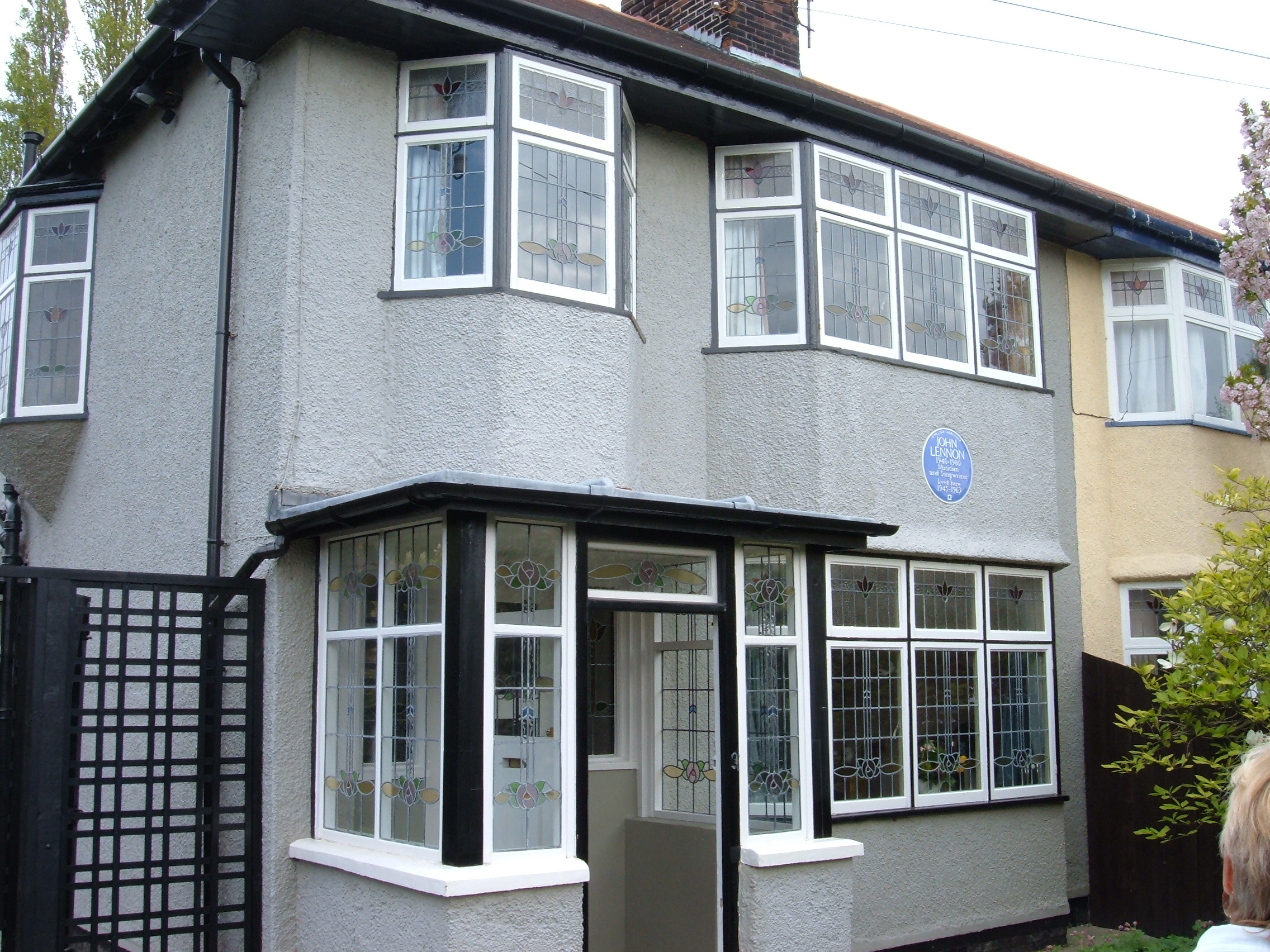 A grey two-story building, with numerous windows visible on both levels