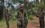 In this Sunday, April 29, 2012 file photo, troops from the Central African Republic stand guard at a building used for joint meetings between them and U.S. Army special forces, in Obo, Central African Republic, where U.S. special forces have paired up with local troops and Ugandan soldiers to seek out Joseph Kony's Lord's Resistance Army (LRA).