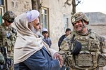 U.S. Army Lt. Col. Mark Martin, right, civil affairs team lead for Provincial Reconstruction Team (PRT) Farah, shakes hands and laughs with Mawlawi Guhlam M. Ruhaani, director of Hajj and Endowment, at the conclusion of a key leader engagement in Farah City, Dec. 29, 2012.