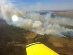 In this photo provided by the New South Wales Rural Fire Service, plumes of smoke rise from a fire near Cooma, Australia, Tuesday, Jan. 8, 2013.