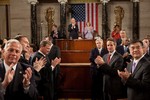 File - Members of Congress, the Cabinet, and Supreme Court applaud as President Barack Obama enters the House Chamber to deliver his State of the Union address to a joint session of Congress, Jan. 27, 2010.