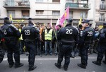 Kurdish activists gather outside a building where three Kurdish women were shot dead, in Paris, Thursday, Jan. 10, 2013. Police say three Kurdish women have been shot dead at a pro-Kurdish centre in Paris in what the French interior minister is calling an execution.