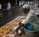 File - Muslims sell food as they celebrate Ramzan Eid in Kolkata on the eve of Eid-ul -Fitr to mark the end of holy month of Ramzan on Monday 20 August 2012.