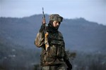 An Indian army soldier patrols near the line of control, the line that divides Kashmir between India and Pakistan, after a reported cease-fire violation, in Mendhar, Poonch district, about 210 kilometers (131 miles) from Jammu, India, Wednesday, Jan. 9, 2013.