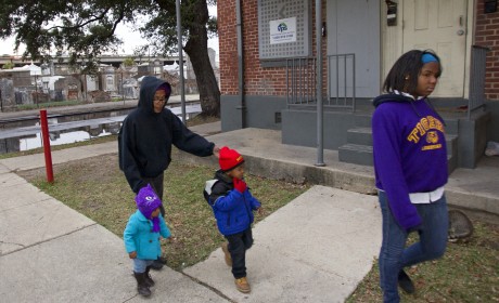 Charmaine Williams, second from left, goes for a walk with her grandchildren Keah Williams, 15 months, left, and Richard 'Ricky' Farrell III, 3; and daughter, SaYann Williams, 16, right, Tuesday in the Iberville public housing development. The development is across the street from St. Louis Cemetery No. 2. Advocate staff photo by Scott Threlkeld.