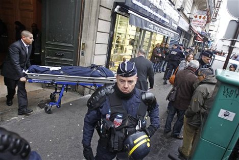 One of the three bodies of the killed Kurdish women is taken out of the building in Paris, Thursday Jan. 10, 2012.