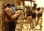  Iraqi soldiers search detainees after a firefight May 22, 2005, in Abu Ghraib, Iraq. The soldiers are participating in Operation Squeeze Play, a major operation to catch insurgents and stop insurgent activity throughout Baghdad&acute;s Rusafa neighborhoo